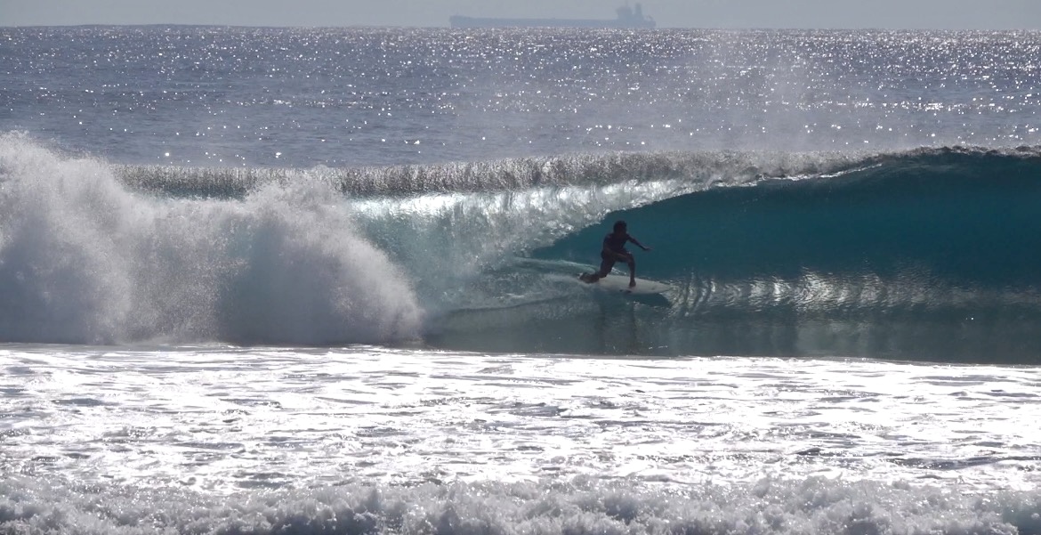 Surfer riding a wave in Lombok